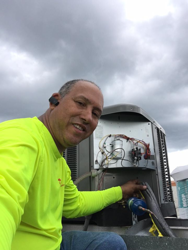 Experienced technician performing outdoor HVAC service work