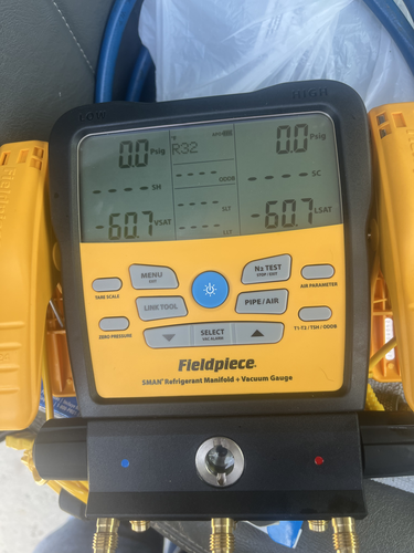 HVAC refrigerant pressure gauges showing professional diagnostic equipment